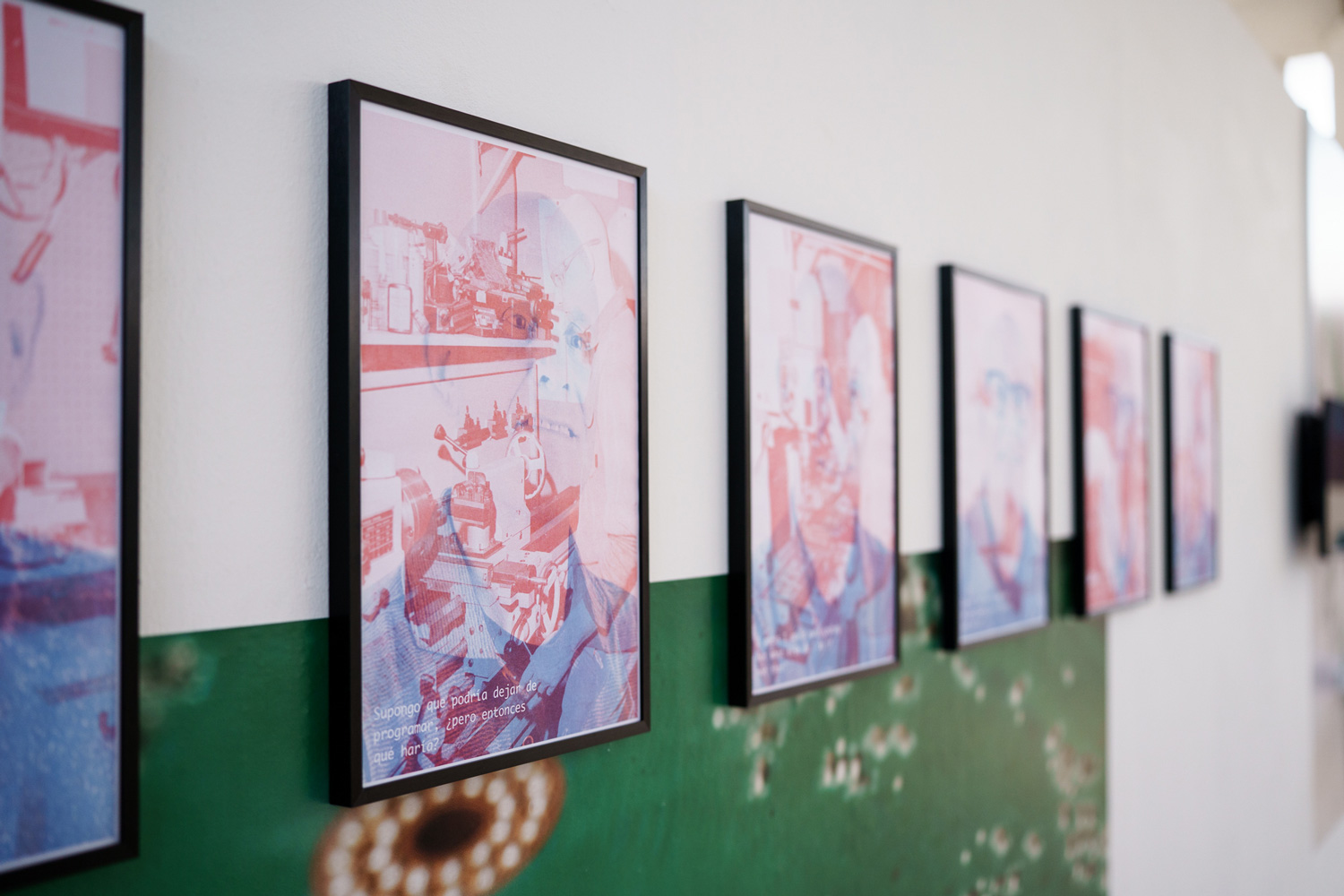 Row of framed risograph posters mounted on a wall printed with a green circuit-board photograph